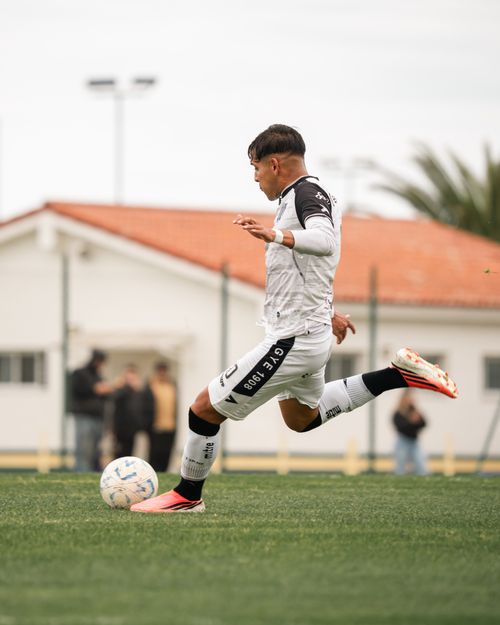 Free Soccer player in action kicking a ball during a daytime outdoor match. Stock Photo