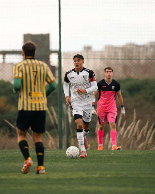 Free Soccer players in action during a lively match outdoors on a sunny day. Stock Photo