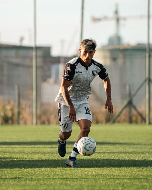 Free Dynamic action shot of a soccer player dribbling during a game on a sunny day. Stock Photo