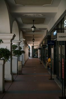 Beautiful indoor shopping arcade with classical arches and ambient lighting.