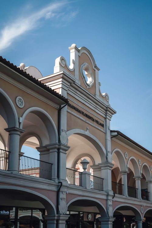 Free Elegant architectural details of Florentia Village against a bright blue sky. Stock Photo