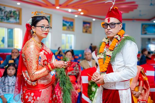 Free A couple dressed in vibrant traditional Nepalese attire during their wedding ceremony. Stock Photo