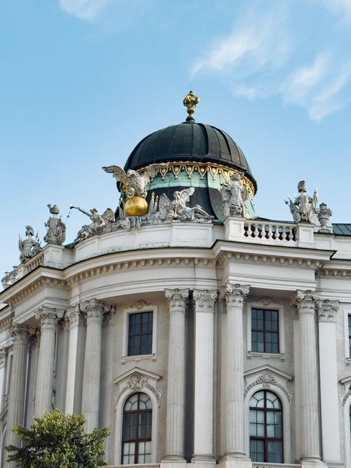 Free Magnificent Baroque architecture of Hofburg Palace with its ornate dome and statues in Vienna, Austria. Stock Photo