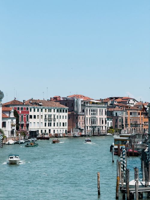 Free Scenic view of Venice's iconic Grand Canal with colorful historic buildings and boats on a sunny day. Stock Photo