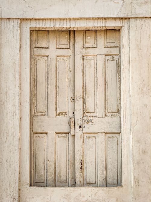 Free Vintage wooden door with peeling paint in a rustic architectural frame, evokes nostalgic charm. Stock Photo