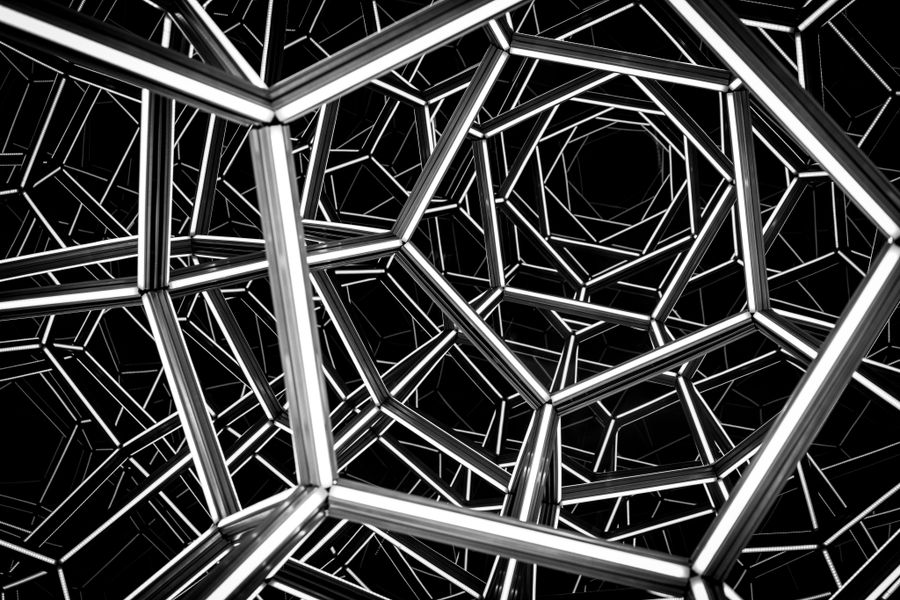Abstract black and white illustration of a complex geometric metal framework, creating a captivating visual illusion.