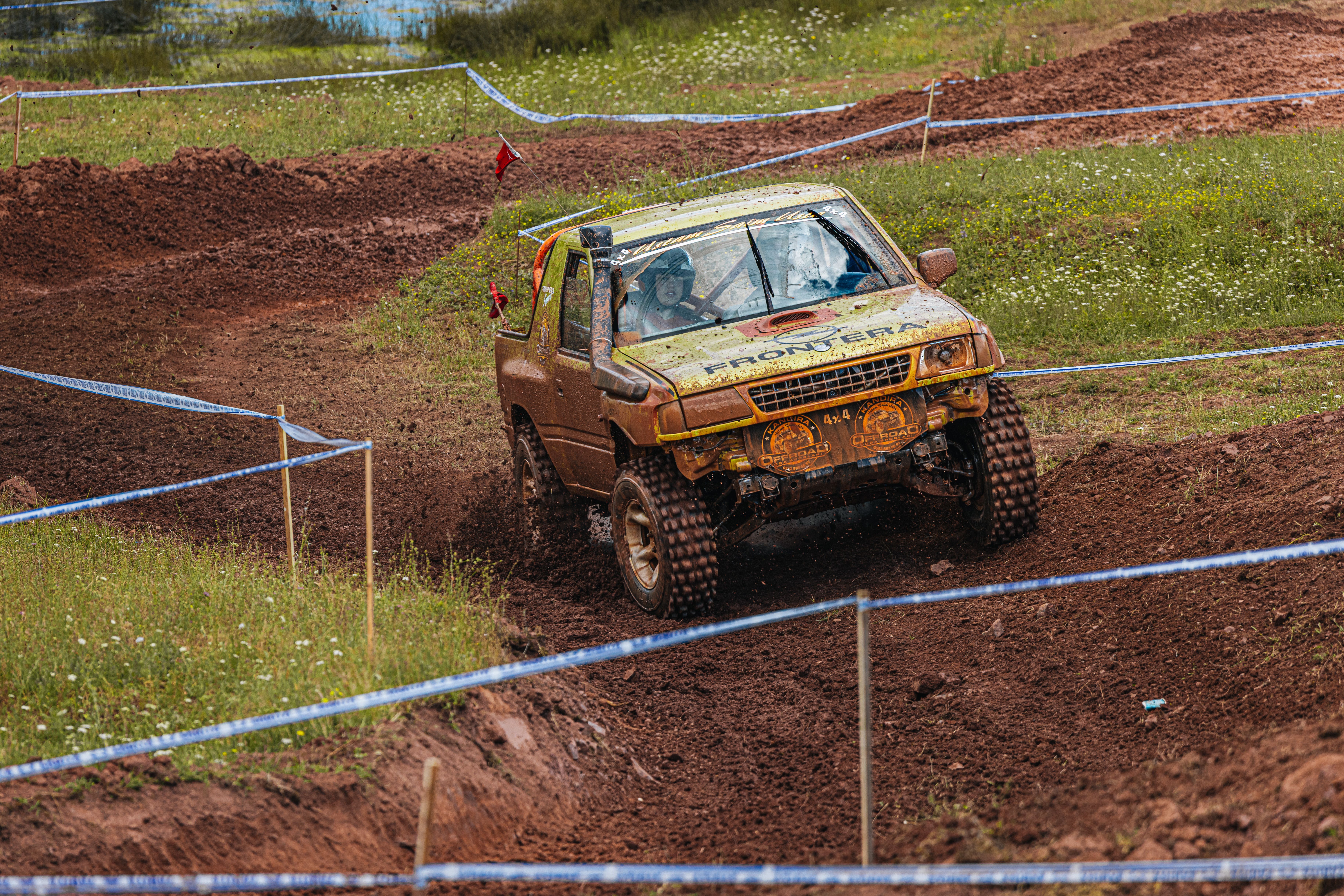A rugged offroad racing truck tackles a muddy track during a thrilling competition.