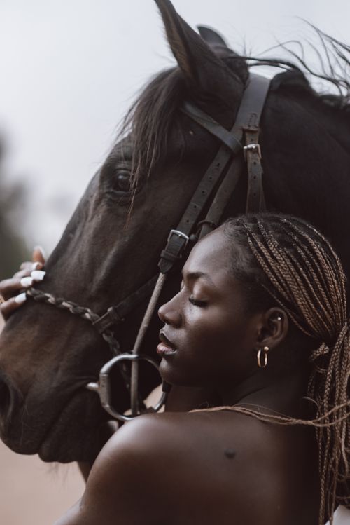 Free An adult woman embraces a horse, capturing a serene moment outdoors. Perfect for lifestyle themes. Stock Photo