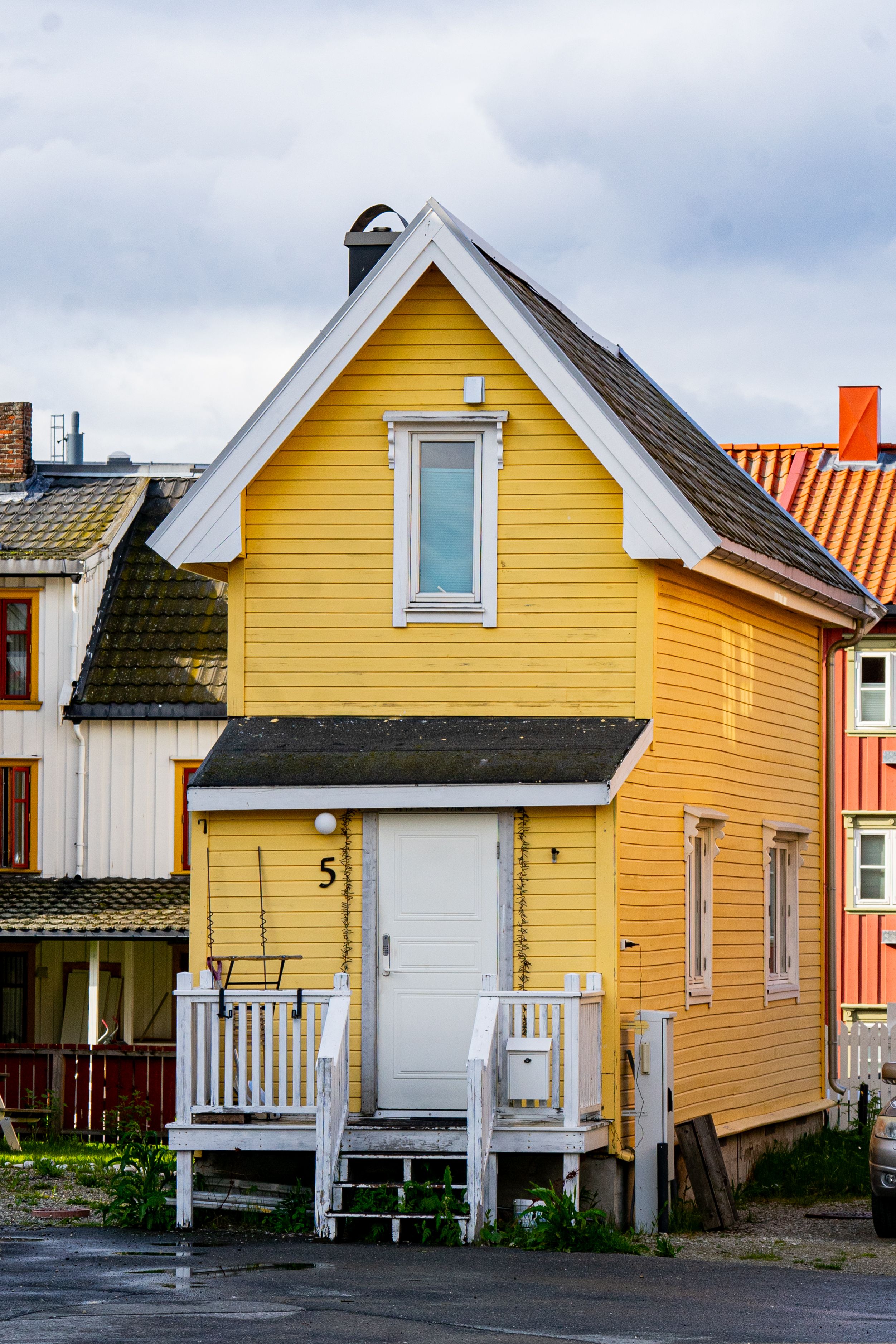 Bright yellow house in Tromsø, Norway with a quaint architectural style.