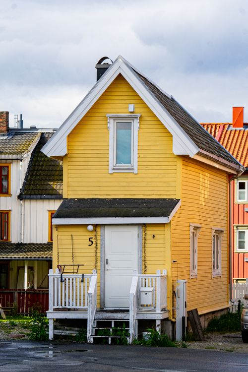 Free Bright yellow house in Tromsø, Norway with a quaint architectural style. Stock Photo