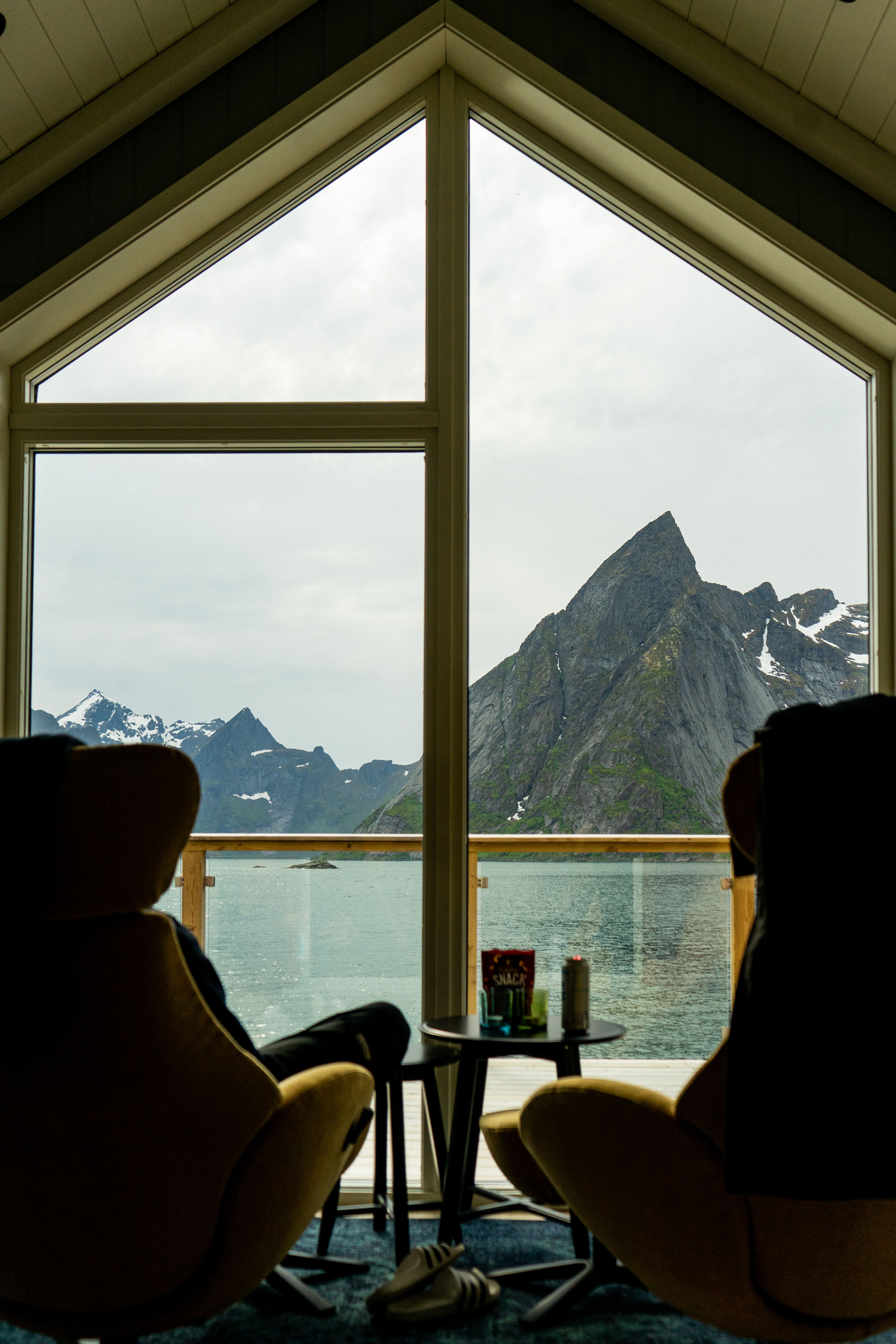 Relaxing view of Lofoten mountains through cabin window, perfect for serene getaways.