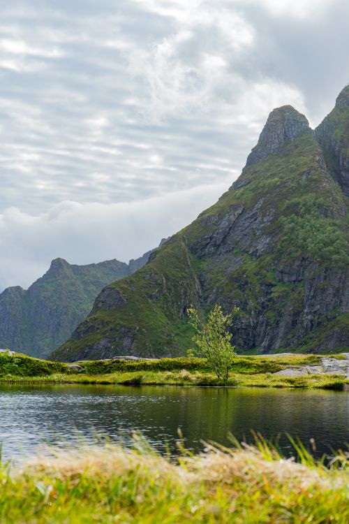 Free Stunning view of mountains and a tranquil lake in Lofoten, Nordland, Norway. Stock Photo