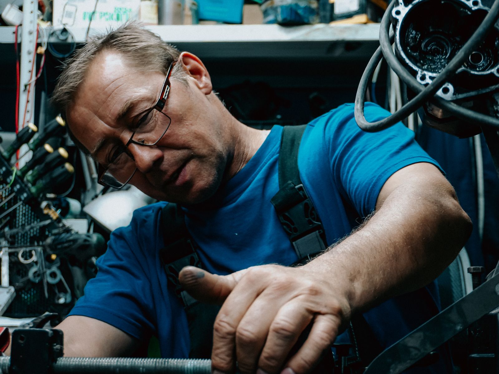 Mechanic repairing an engine inside a workshop