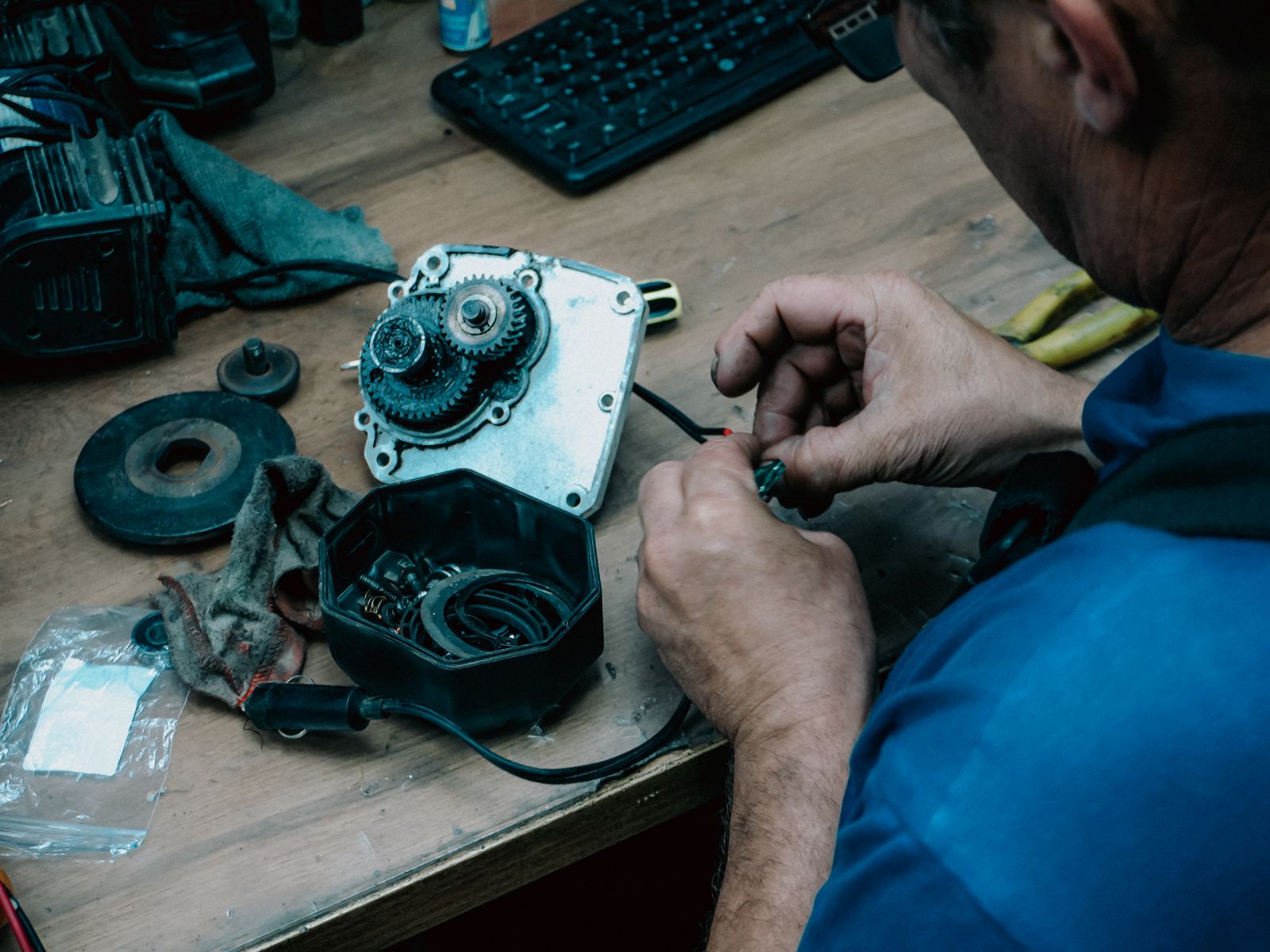 Technician repairing a mechanical gear system