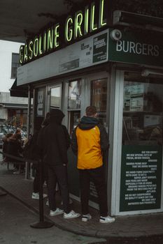 Urban snapshot of people in line at Gasoline Grill, famous for burgers in Copenhagen.