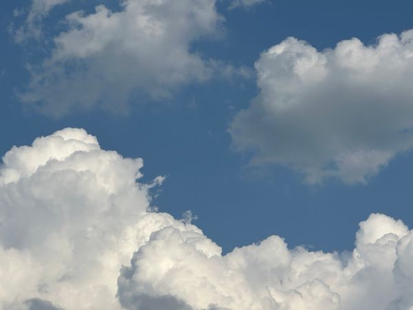 Cumulus clouds floating in a bright sky — photo by James Servant on Pexels