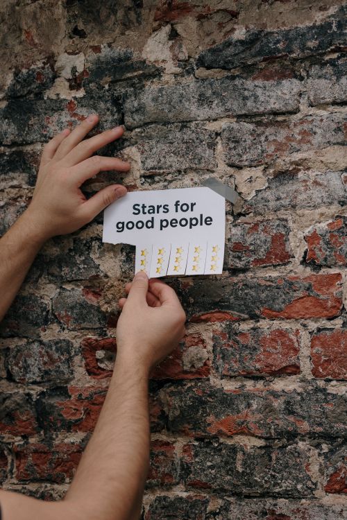 hands taping paper stars feedback