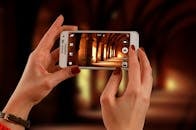 Woman Holding a White Samsung Galaxy Android Smartphone Taking a Photo of Hallway