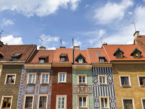 Vibrant historic buildings in Poznań, showcasing unique architecture in the old town square.