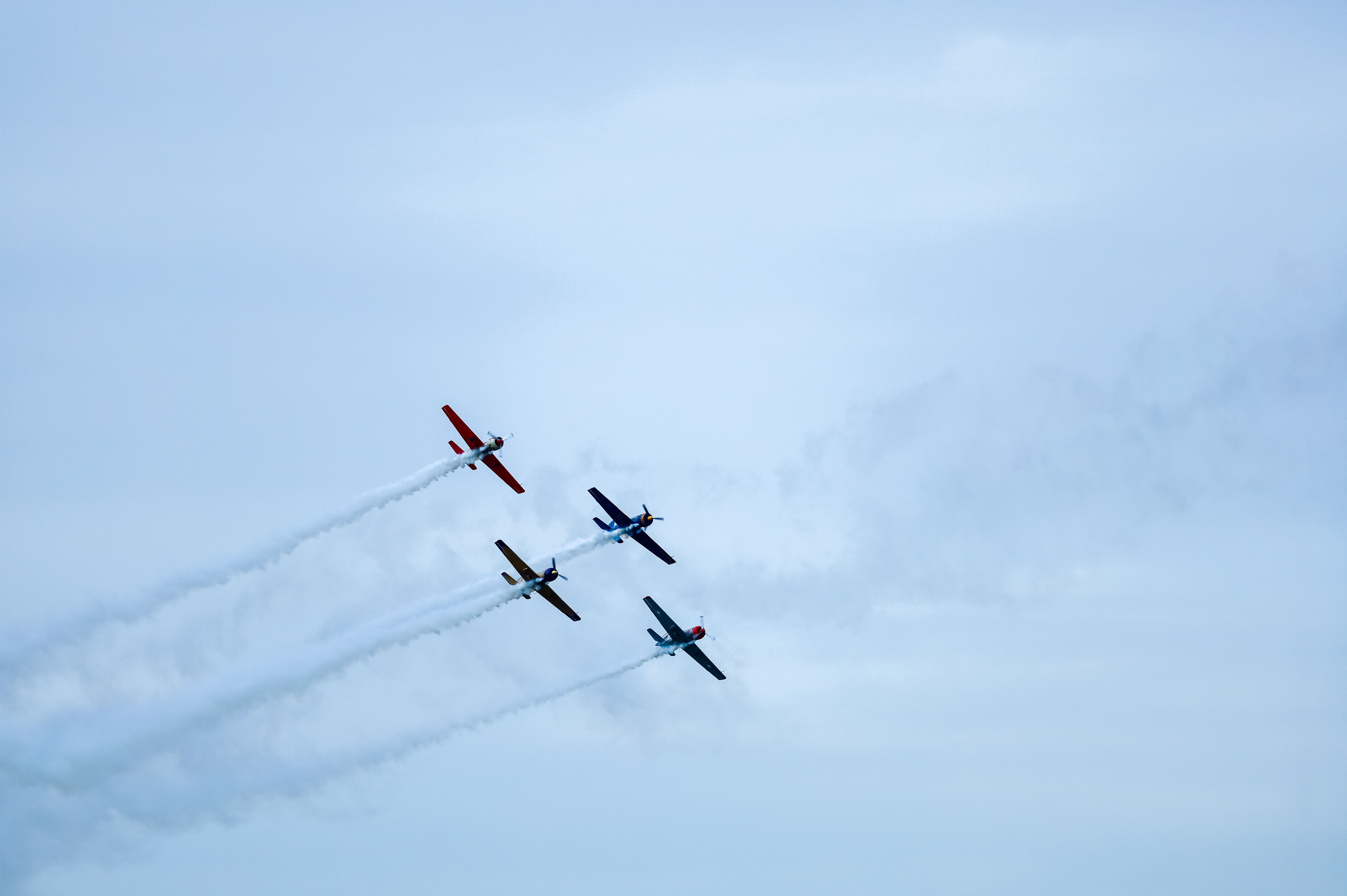 Thrilling aerobatic performance by colorful airplanes over Lisbon, Portugal. Perfect display of flying skill and teamwork.