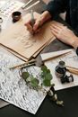 Person Writing on Brown Paper