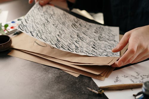 Person Holding White Paper with Handwritten Text