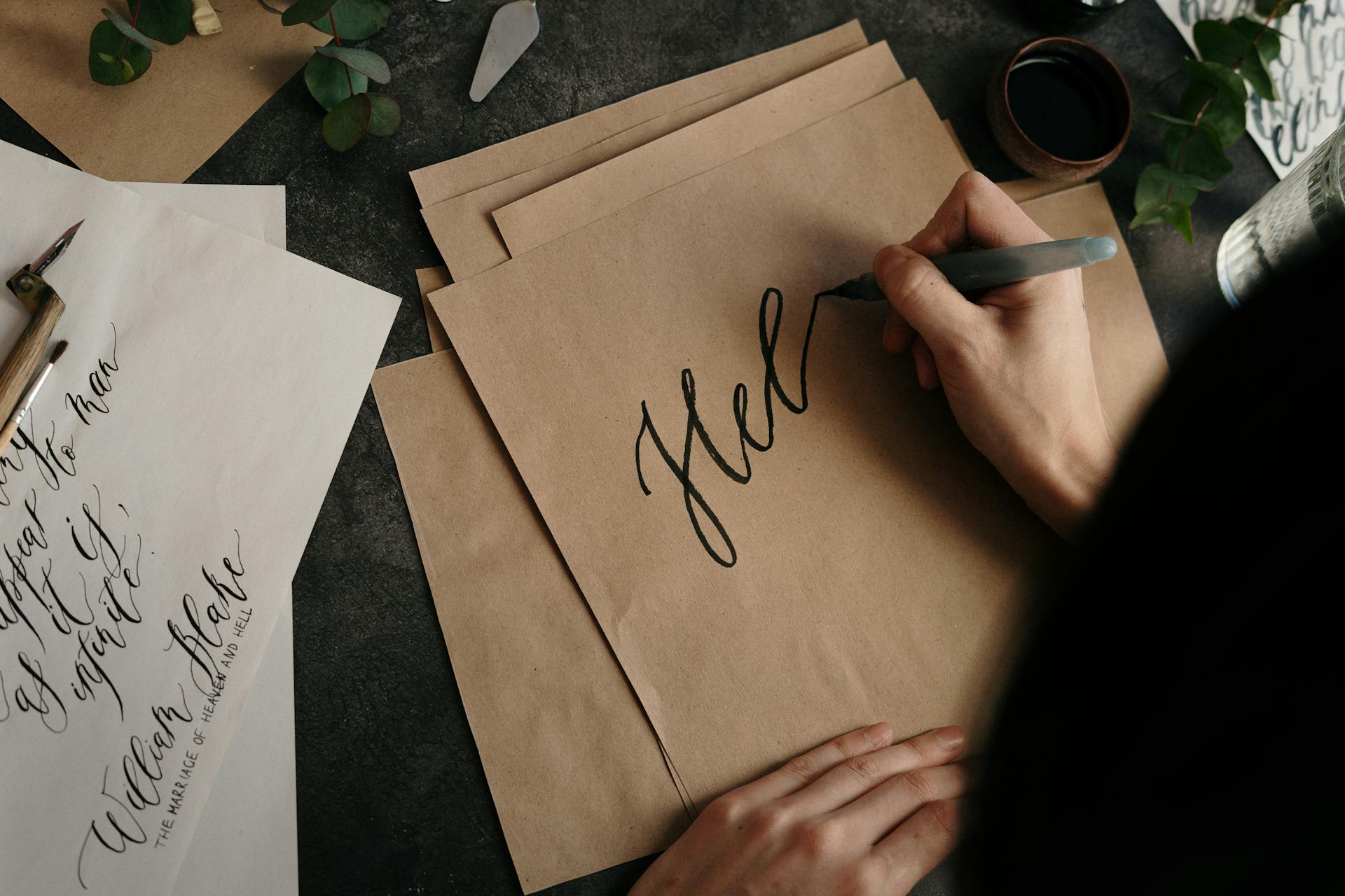 Person Writing On Brown Paper