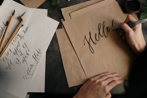 Person writing on a  Brown Parchment Paper 