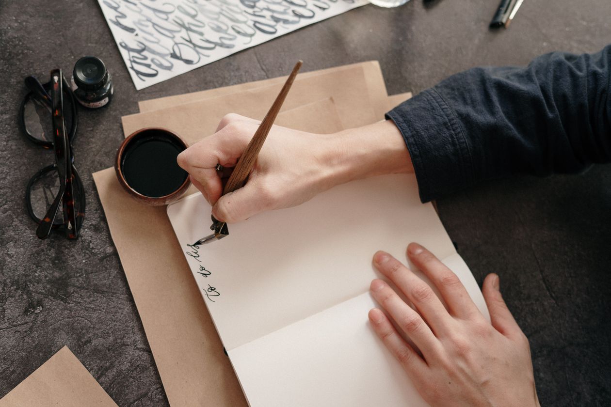 Fountain pen and notebook on a wooden table — left-handed writer daily setup