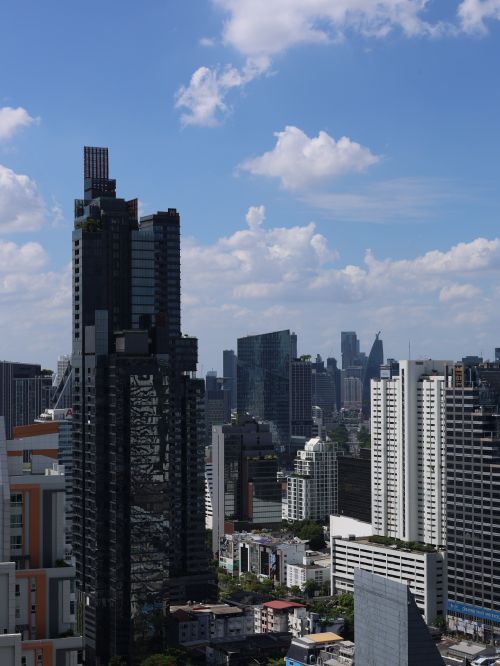 Free A striking view of a modern city's skyscrapers under a clear blue sky. Stock Photo
