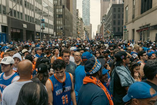 Thriving street celebration with a diverse crowd in New York, showcasing excitement and unity.
