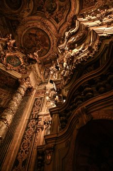 Stunning low-angle view of intricate Baroque architecture details with rich golden tones.