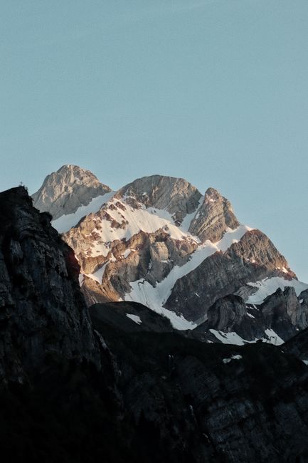 Captivating view of the Alpstein mountain peaks bathed in sunrise light in Schwende-Rüte, Switzerland.