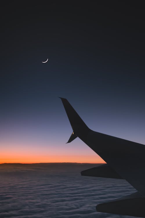 Airplane Flying over the Clouds 