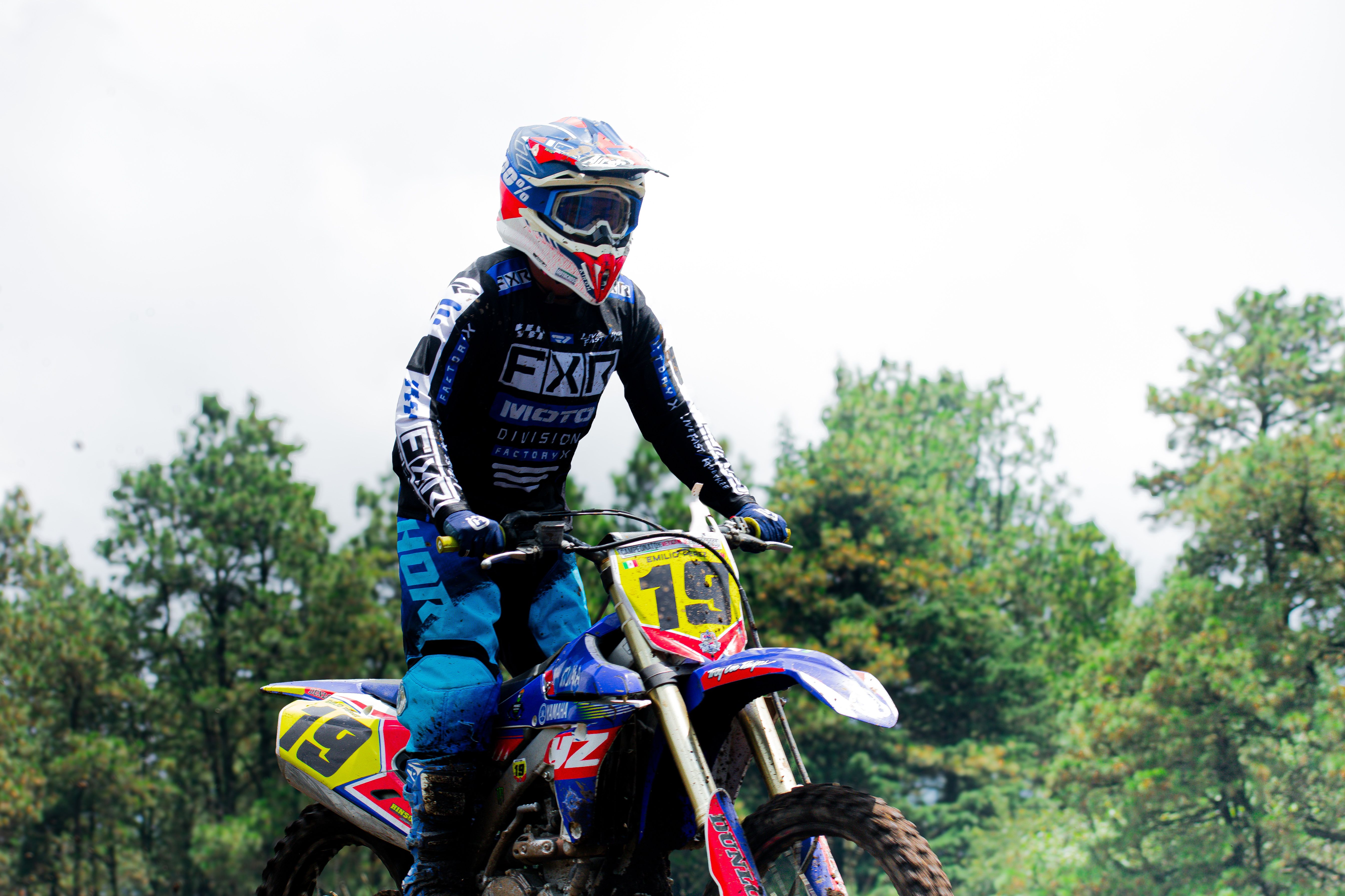 Dynamic shot of a motocross rider speeding through a forest trail in Mexico.