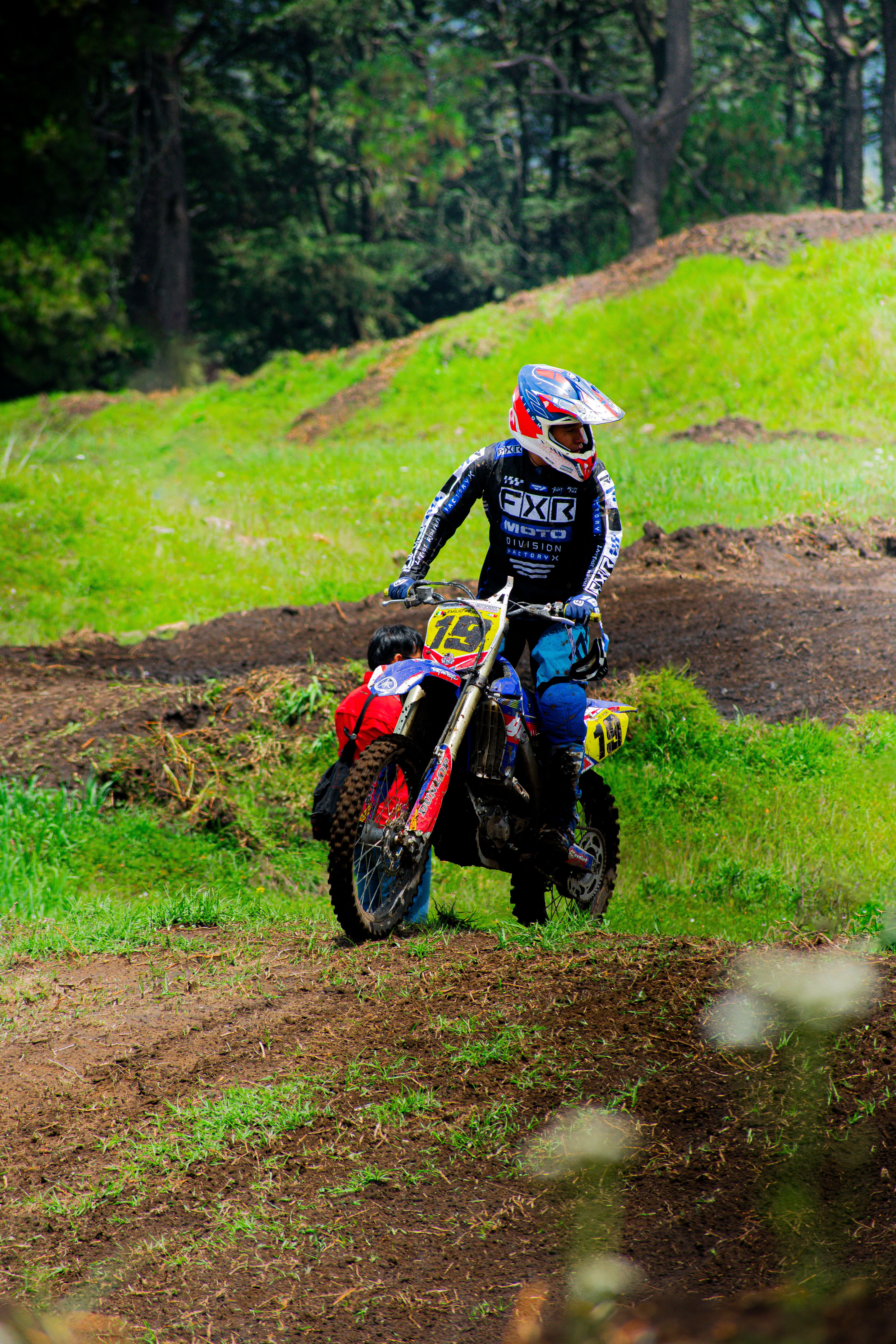 Motorcyclist in colorful gear races through the lush, vibrant landscape of Mexico, showcasing speed and agility.