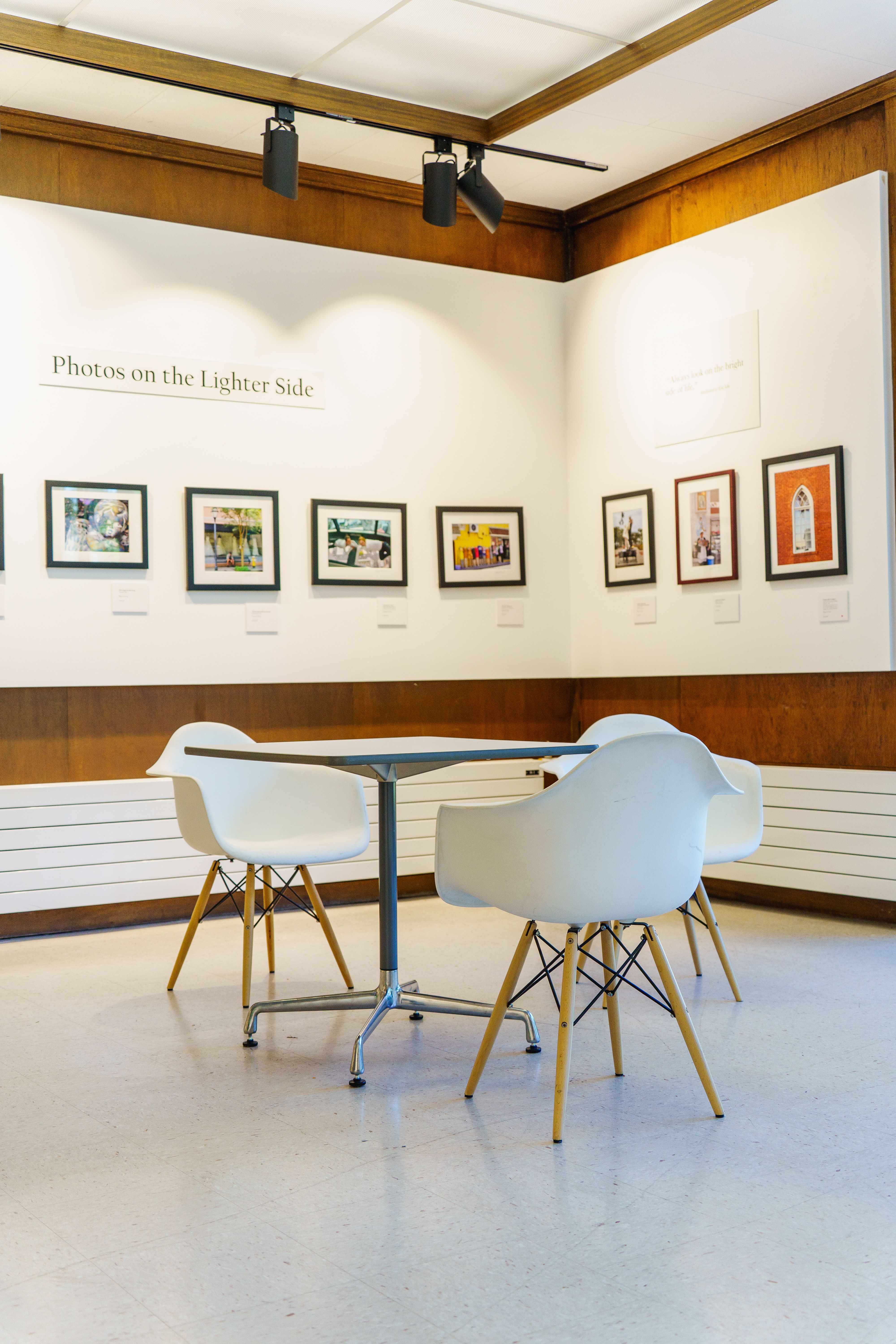Contemporary art gallery with modern chairs and displayed artwork.