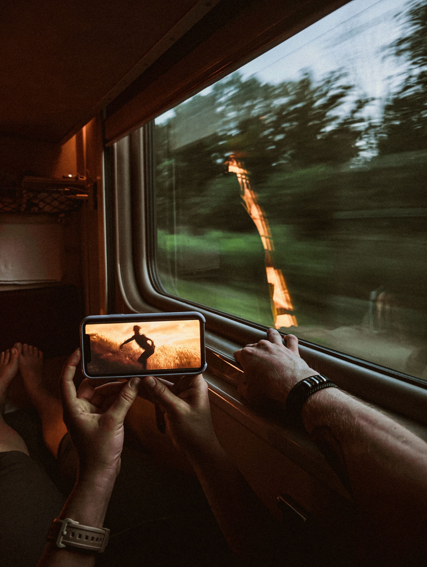 A smartphone held near a train window during a journey