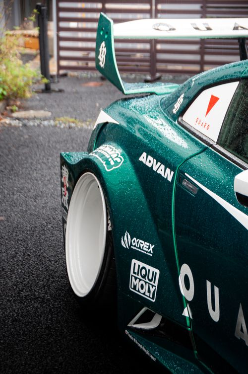 Free Close-up of a green sports car showcasing its rear and distinctive decals in Tokyo, Japan. Stock Photo