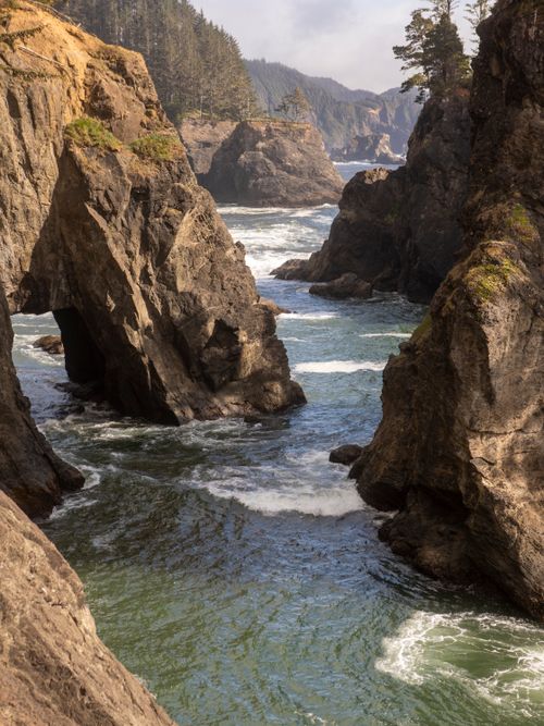 Free Stunning coastal scene of rocky cliffs and sea arches along the coastline. Stock Photo