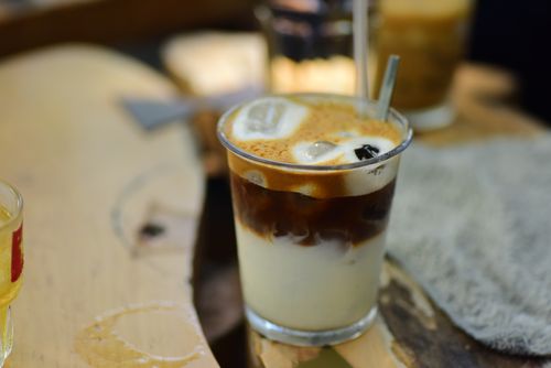 Free Close-up of a refreshing iced coffee with milk served in a glass with a straw. Stock Photo