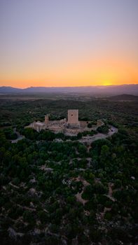 Aerial view of Ulldecona Castle in Catalunya, Spain during a vivid sunset.