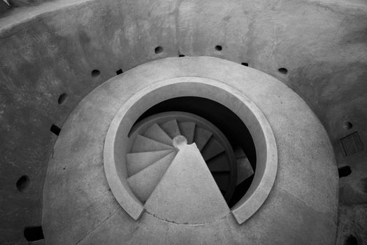Black and white image of a spiral staircase in a modern architectural setting in Qatar.