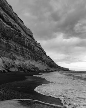 Stunning black and white photo of ocean waves against dramatic cliffs in Argentina.