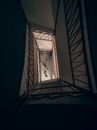 Long staircase with railings inside of building