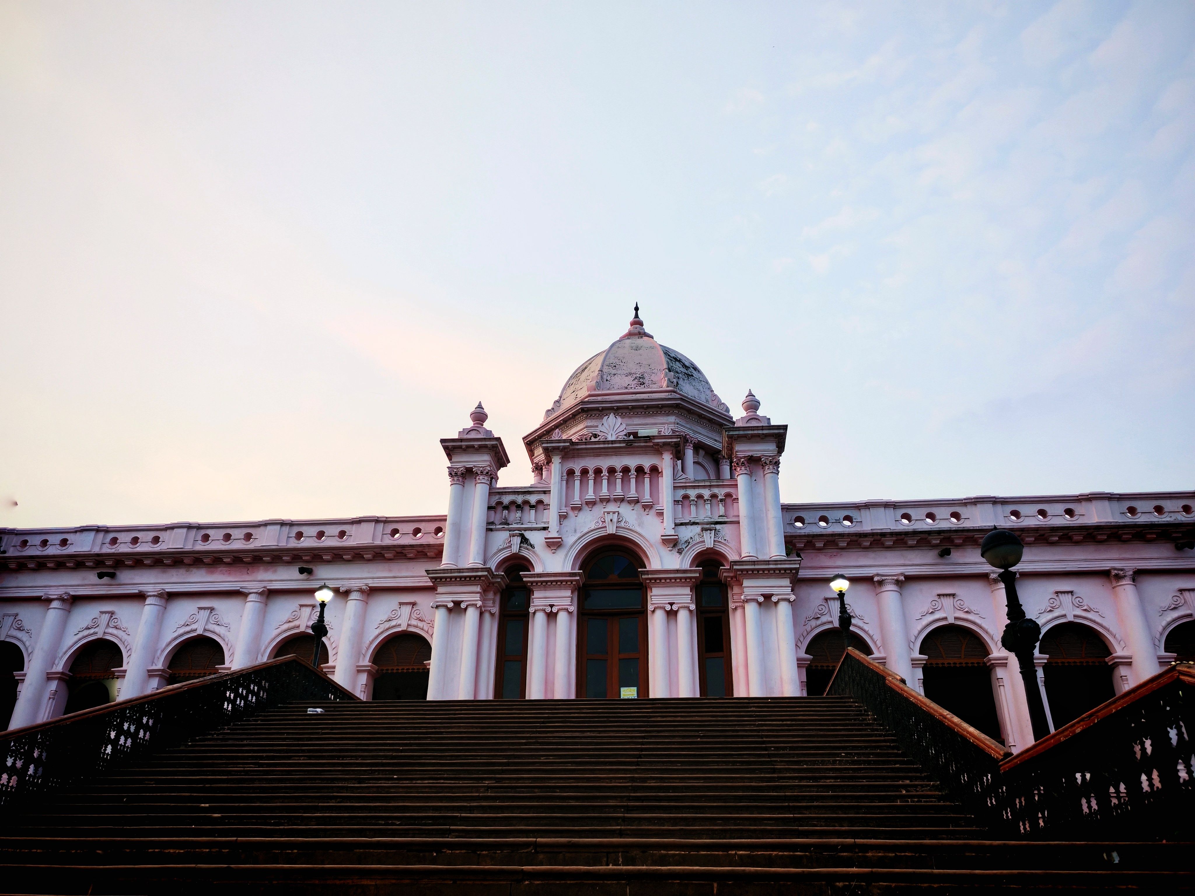 Captivating view of Ahsan Manzil palace at dusk, showcasing its stunning architectural features in Dhaka.