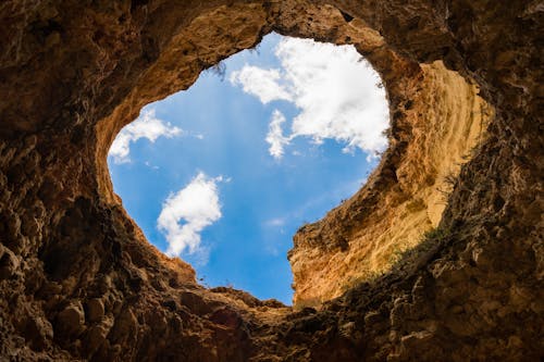 Worm's-eye Photography of Hole Under Cloudy Sky