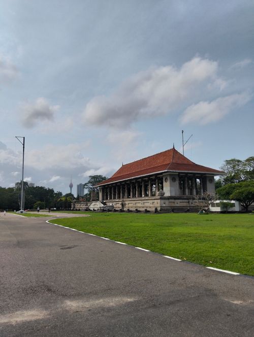 Free Scenic view of Independence Memorial Hall in Colombo with lush green surroundings under a cloudy sky. Stock Photo