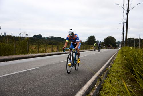Free Cyclist competes in a road race in Quatro Barras, Brazil, showcasing endurance and speed. Stock Photo