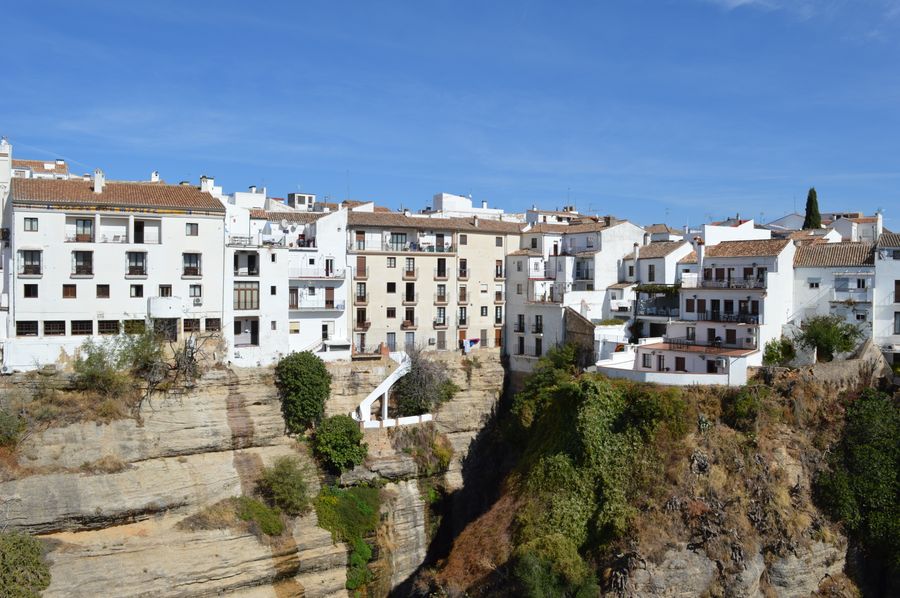 White houses of Ronda on the edge of a cliff in the Andalusian landscape